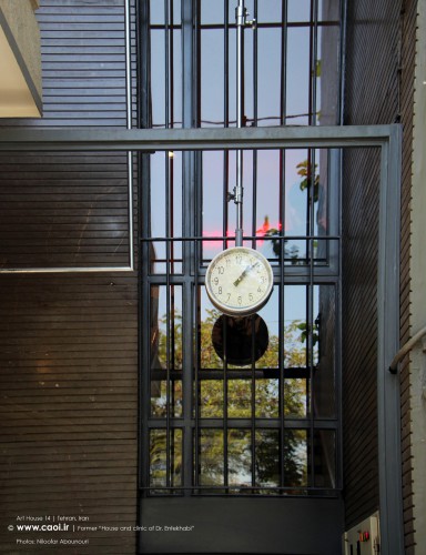 A hanging clock in the main entrance of the Art House 14